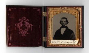 alt="photo of antique daguerreotype picture frame in a velvet covered box containing Charles Journeycake's seated portrait"